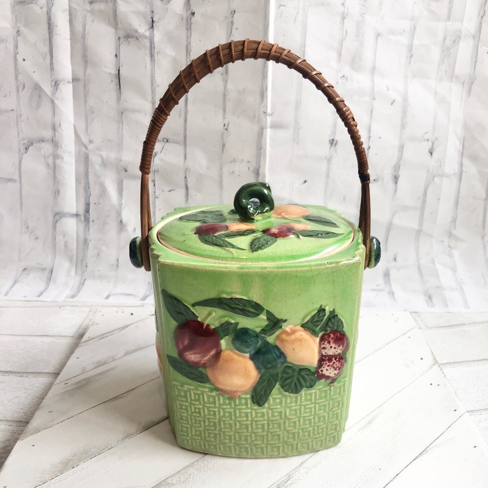 Vintage Green Majolica biscuit jar with fruit details and wicker handle